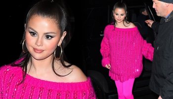 Selena enters the SNL after-party wearing a glittery, oversized pink sweater and Valentino heels