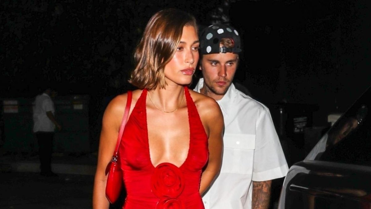 The model's 'strawberry' era continues with her red off-shoulder dress and 'B' necklace